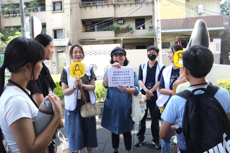 《圖說》新莊社區大學講師王惠靜（中）為兒少解說先人開墾新莊平原建設的劉厝圳、張厝圳，並要兒少搶答。左3為綽號「大飽」的新莊少年福利中心主任許巽絜。〈社會局提供〉